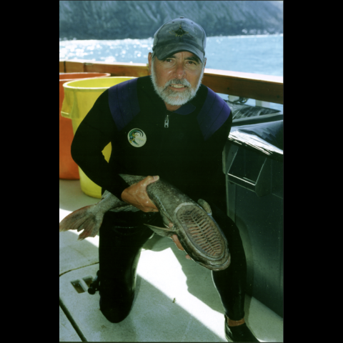 Robert Rubin on a boat with a fish